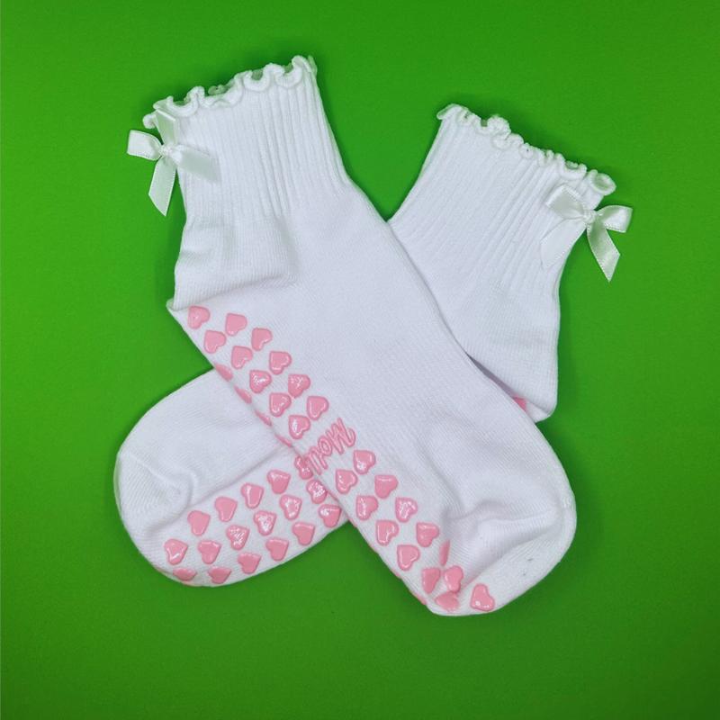 White ruffle grip sock with white bow and pink heart grips for pilates, yoga, lagree or barre