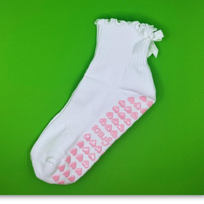 White ruffle grip sock with white bow and pink heart grips for pilates, yoga, lagree or barre